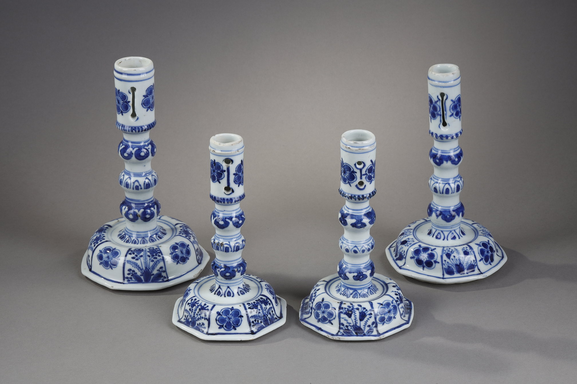 Very rare suite of four candle holders in blue white porcelain of European shape